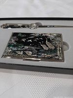 Letter opener and cardholder set in presentation box, detailed view of the cardholder with bird and nature design in mother of pearl.