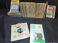 Group shot showing Peanuts and MAD paperbacks plus Playtime record