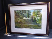 Full view of framed painting with yardstick and tape for scale