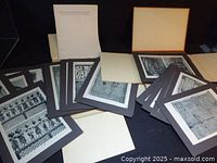 Interior view with multiple mounted black-and-white prints and text sheets