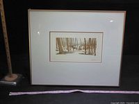 Front view of framed signed landscape print with measuring tape for scale