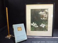 Framed dogwood print, BC Centennial book, ruler on stand displayed together