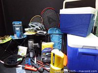 overview of assorted camping items including coolers, stool and accessories