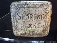 Aged Ogden's St. Bruno Flake tobacco tin showing full front lid graphics
