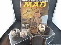 Full lot view showing Mad Magazine, four geodes, two agate slices
