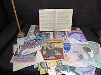 Spread of all sheet music pieces on sofa, shows quantity and variety