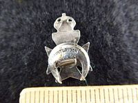 Back of silver regimental badge showing pin fastener and J.R. Gaunt London mark