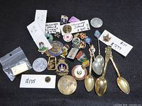 overview of assorted pins, spoons, coins and bar