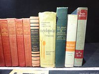 Row of hardcovers showing titles including Eisenhower, Hall Caine series, Bruno Frank, Encyclopedic Cookbook, Great Events, Great Democracies, Douglas MacArthur