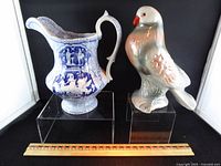 Pitcher and pigeon figurine with ruler for scale