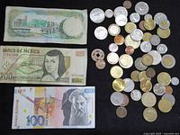 Overview showing three banknotes and pile of mixed coins