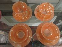 Four teacup and saucer sets displayed top view