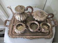 Full view of entire six-piece tea set on tray