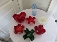 Top view showing all six glass bowls with water bottle for scale