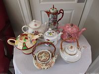 Group shot of all seven teapots on table