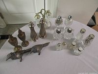 All nine salt and pepper shaker sets grouped on table