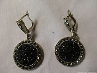 Front view showing black central stone and surrounding clear stones