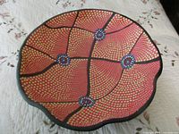 Top view showing full interior pattern of red, yellow dots, blue rosettes