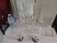 Group shot of all thirteen crystal and pressed glass pieces on table