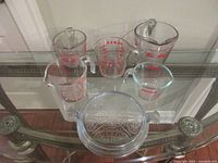 Front view of all six pieces showing brands and red graduations