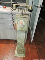 Full view of marble pedestal telephone