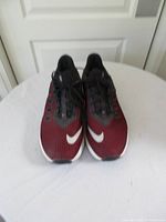 Front view of both Nike shoes showing toe Swoosh logos and laces