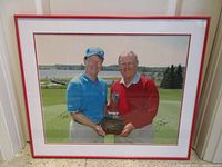 Front view of framed autographed photo showing image, signatures, mat and frame