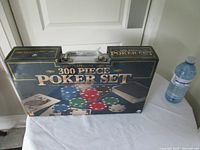 Boxed Traditions 300 Piece Poker Set beside water bottle for scale