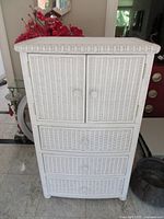 Front view showing double doors and three drawers