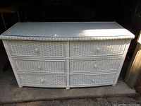 Front view of white rattan dresser showing six drawers