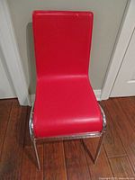 Front view of red upholstered chair showing seat and legs