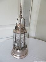 Full view of pickle castor jar on base showing glass insert and handle