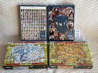 Four puzzle boxes displayed: two Doctor Who puzzles at the back and two Marino Degano Funky Zoo puzzles in front, highlighting the artwork and box fronts.