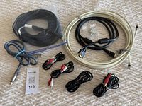 Various audio visual cables laid out on a surface, showing HDMI cable, coaxial cable, VGA cable, RCA cables, and a grey mystery cable.