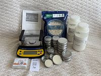 Full lot showing precision balance, pill capsules, metal tins, powder bottles, and user manual