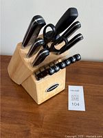 Knife block with knives inserted and kitchen scissors visible in block.