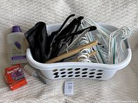 Laundry basket, hangers, black suit cover inside basket, Bounce dryer sheets, Eco Max detergent, sticky moth trap