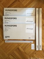 Photo of all boxed KUNGSFORS shelves and rails laid out on floor