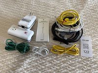 Photo showing all cables and adapter laid out on a textured surface.