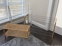 Photo showing all three shoe racks together on a floor with sunlight coming through a nearby window, depicting their material and size differences.