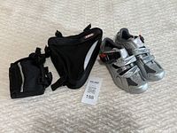 View of the Specialized Ruby women's cycling shoes in silver size 36 next to two black bike bags: Abus triangular frame bag and Topeak compact top tube bag.