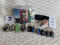 Overview of travel sewing kits, ear plugs, European plug adapter, various locks including combination and TSA key locks.
