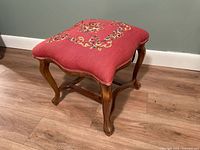 Full view of footstool showing oak frame and needlepoint top