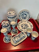 All 13 Blue Danube porcelain pieces arranged on red tray