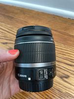 Side view of Canon EF-S 18-55 mm lens held in hand