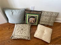 Group of five decorative throw pillows