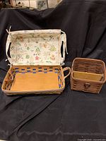 Two Longaberger baskets on black cloth background, showing both as a set for scale and comparison