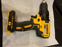 Right side view of yellow and black DeWalt cordless brushless drill without battery.