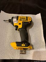 Side angle view of the DeWalt DCF885 cordless impact driver showing the yellow and black body, 20V max label, and bit attached.