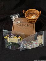 Complete set with basket, original box, silk pansy insert, plastic liner, protective tag and tie-on label